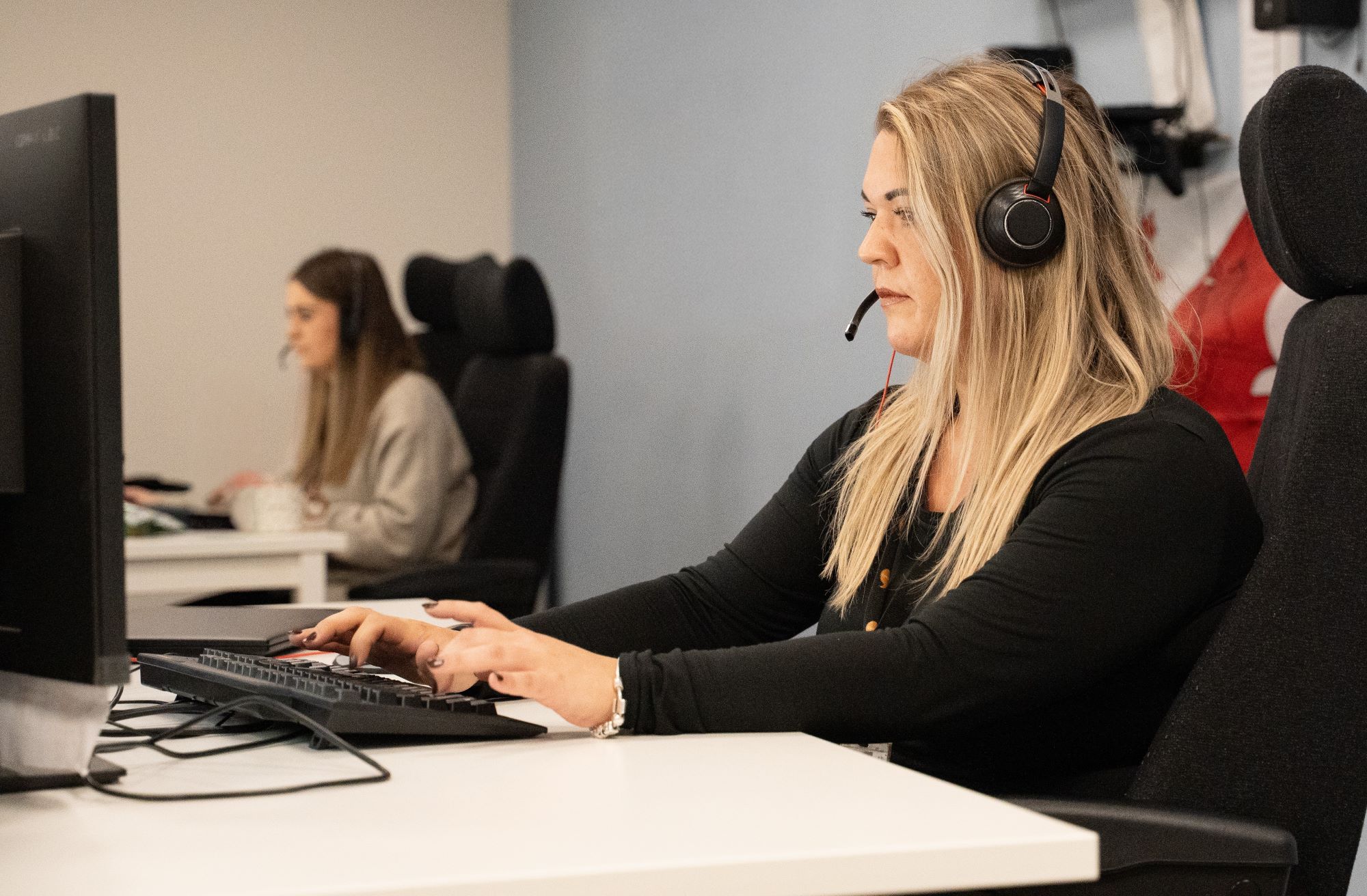 Call centre operatives working at computers.